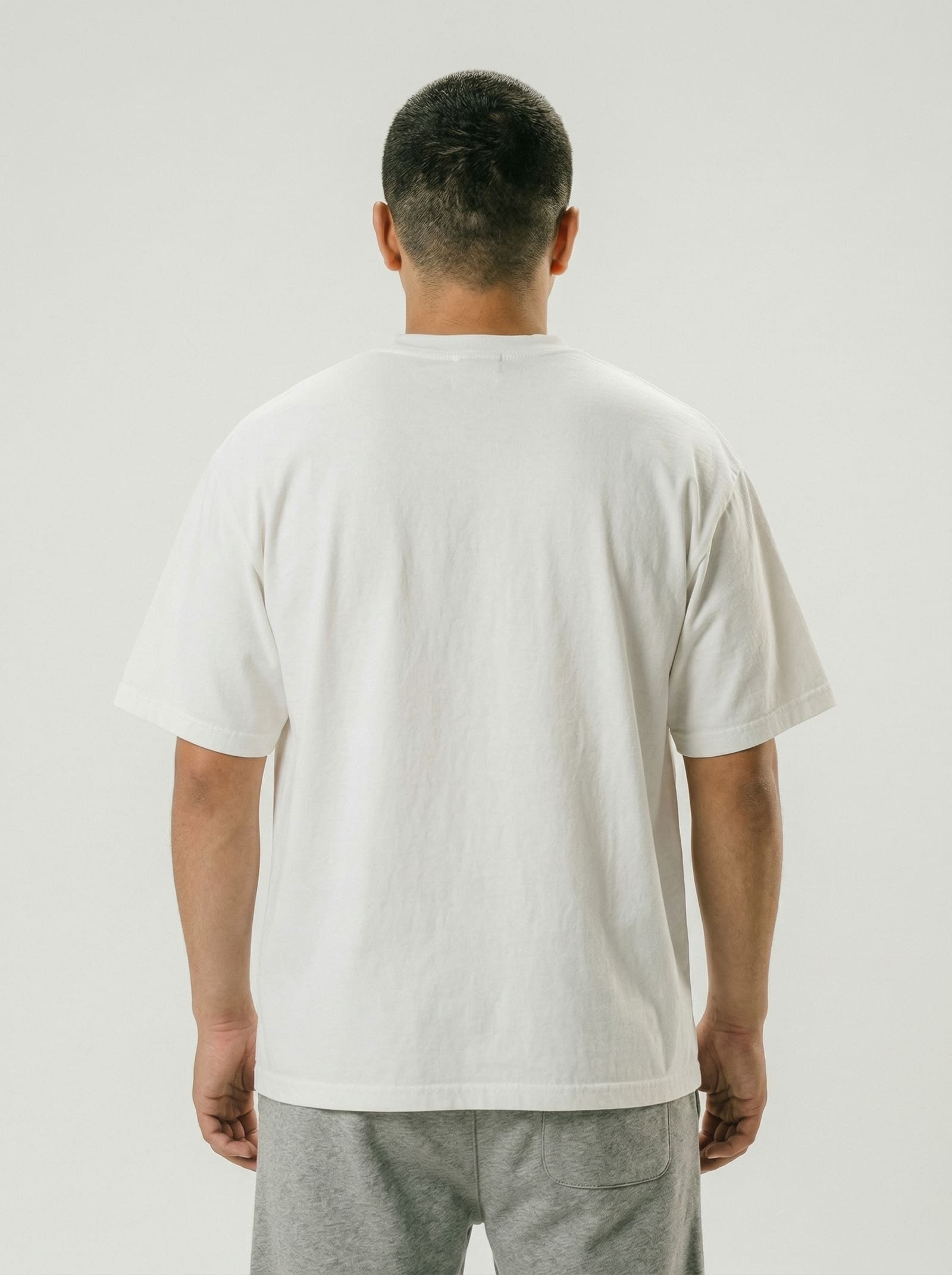 People Power tee back view - model showing back of white tee